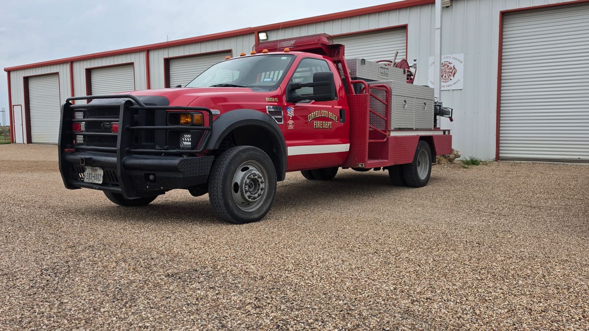 Brush 45, a red Ford F-550 brush truck with diamond-plate tool boxes, parked outside the station