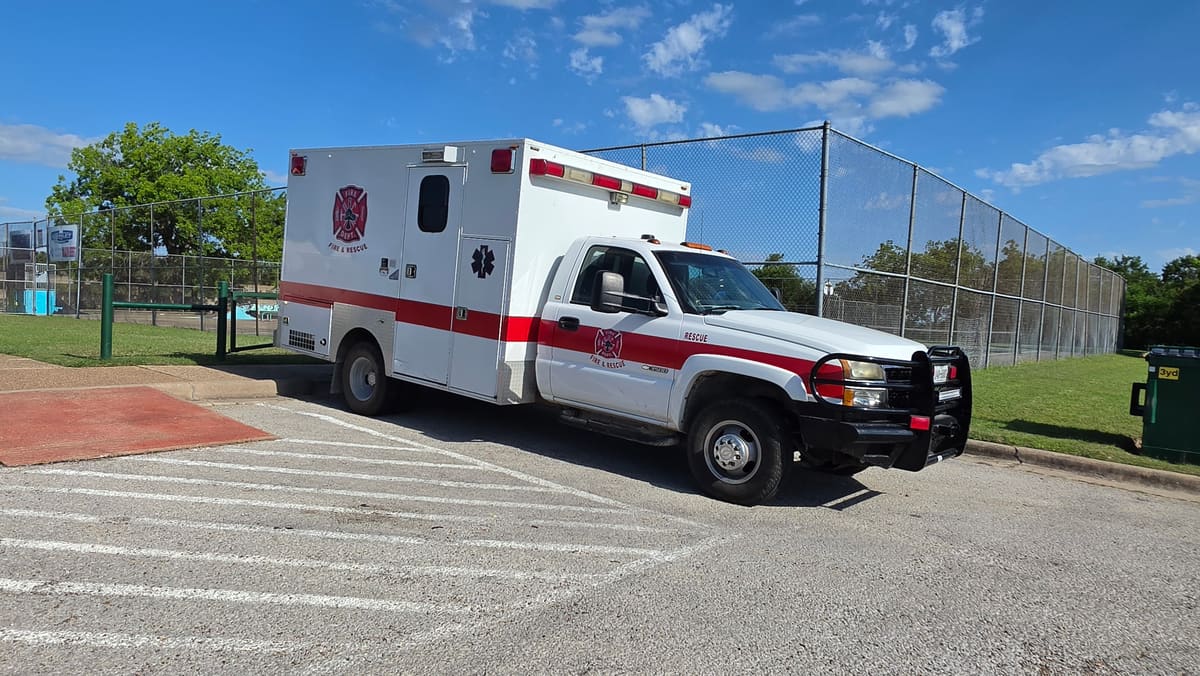 Rescue 46, a white heavy rescue truck with a red stripe and enclosed equipment body